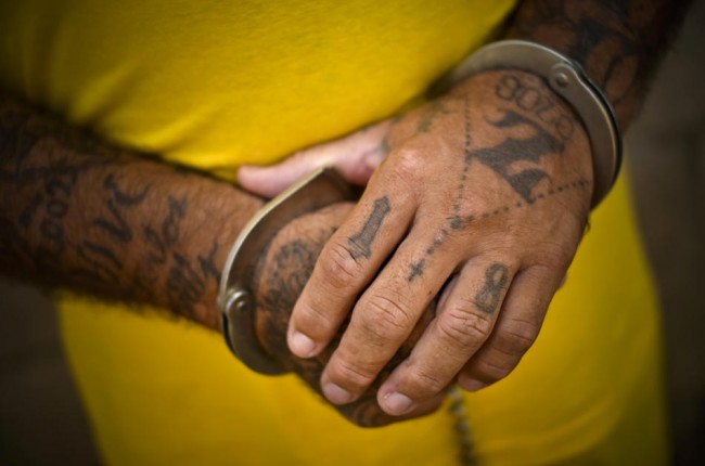The handcuffed hands of a member of a gang known as Mara 18 in the prison yard at the Izalco jail in Sonsonate, El Salvador.