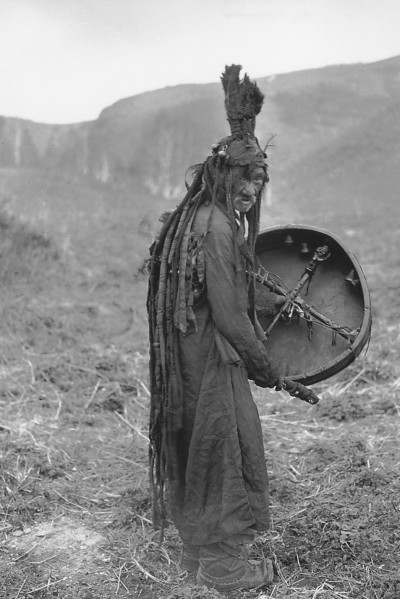 A Mongolian shaman holding a drum. 