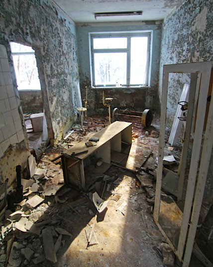 An abandoned medical examination room in the hospital, littered with medical instruments