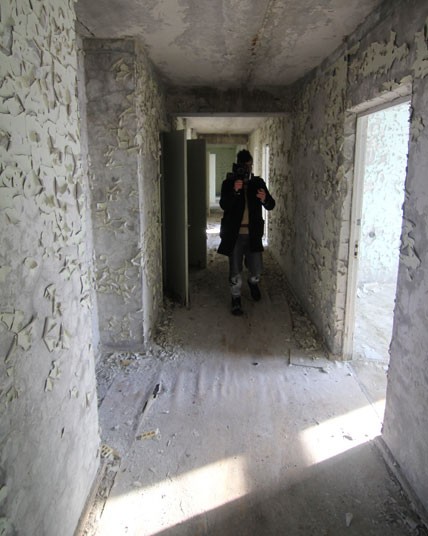 A Ukranian government escort walks in a corridor on the seventh floor of Hotel Pripyat