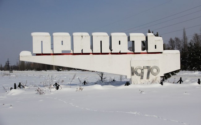 Concrete road-sign that reads 'Pripyat'