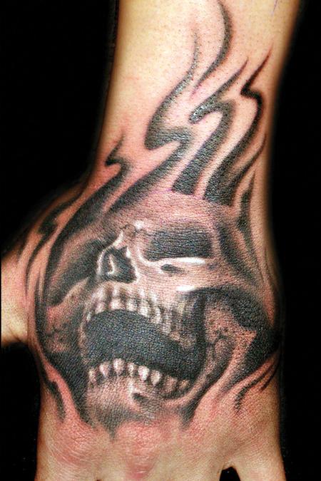 Skull-on-Hand-Tattoo--Black-and-Gray