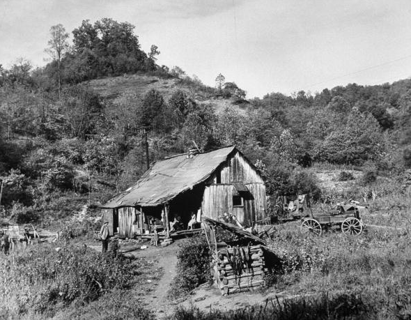 Small coal mining town in impoverished Appalachia, seven family members living in small shack. 1953