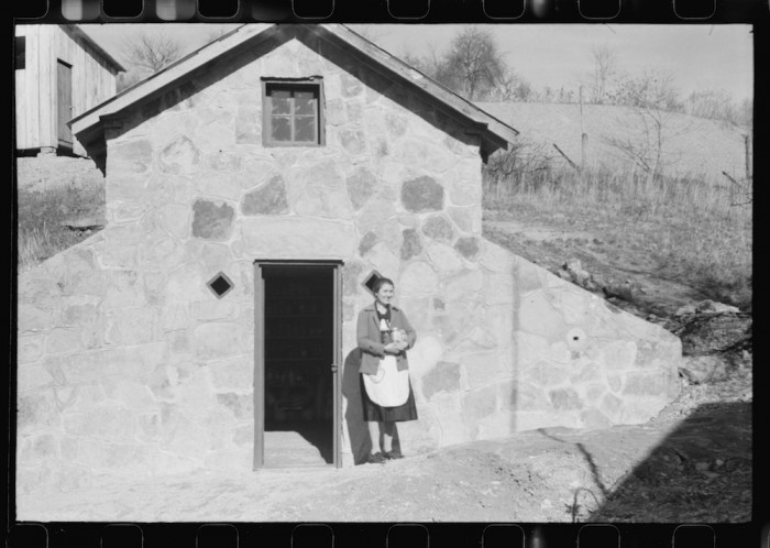 Mrs. S. Castle or Mrs. William S. Allen with canned goods in front of new storage house her husband built on their farm with FSA (Farm Security Administration) help. Southern Appalachian project, near Barbourville, Knox County, Kentucky 1940