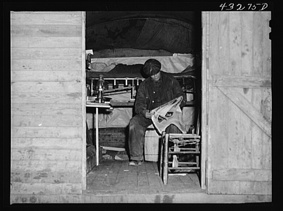 This man is a carpenter at Fort Bragg, North Carolina. This converted truck is his home. The interior of his truck was more roomy than most of the cabins that had been built at the camp where he was staying. At a settlement near Silver Lake, North Carolina (about ten miles out of Fayetteville, N.C.) Creator(s): Delano, Jack, photographer Date Created/Published: 1941 Mar.