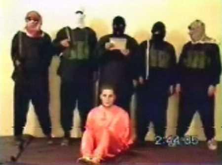 "Nick Berg seated, with five men standing over him. The man directly behind him, said to be Zarqawi, is the one who beheaded Berg."https://en.wikipedia.org/wiki/Nick_Berg