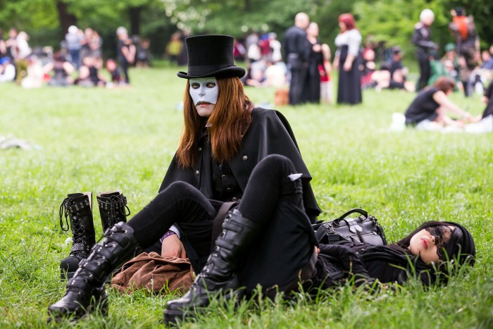 LEIPZIG, SAXONY - MAY 17:  A goth couple wearing masks rest on the lawn during the traditional park picnic on the first day of the annual Wave-Gotik Treffen, or Wave and Goth Festival, on May 17, 2013 in Leipzig, Germany. The four-day festival, in which elaborate fashion is a must, brings together over 20,000 Wave, Goth and steam punk enthusiasts from all over the world for concerts, readings, films, a Middle Ages market and workshops.  (Photo by Marco Prosch/Getty Images) ORG XMIT: 169024637
