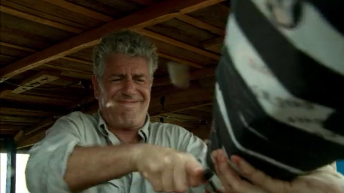 Bourdain haphazardly killing a chicken while crossing the Congo during Parts Unknown, screenshot by the author.