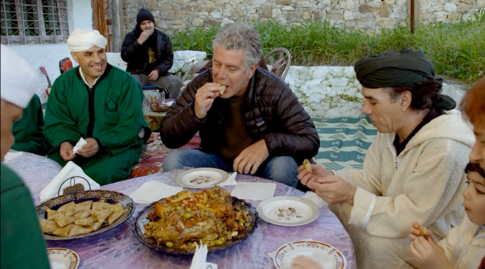 Chef Bourdain eating with his hosts during an episode of Parts Unknown, screenshot by the author.