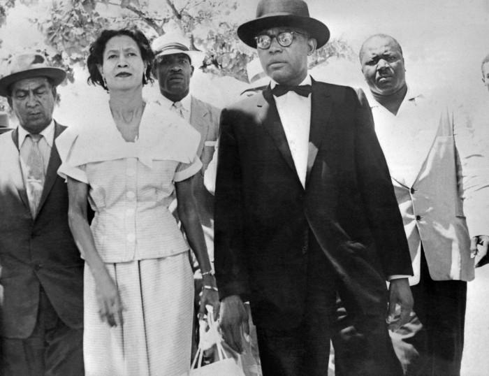 François Duvalier is shown with his wife Simone after they voted in Haiti's presidential election, September 1957, in which Duvalier was a leading candidate. The men in background are Duvalier's bodyguards.
