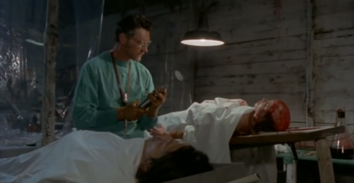 A mad scientist performs a brain transplant from the living to the dead, in Zombie Holocaust, screenshot by the author.