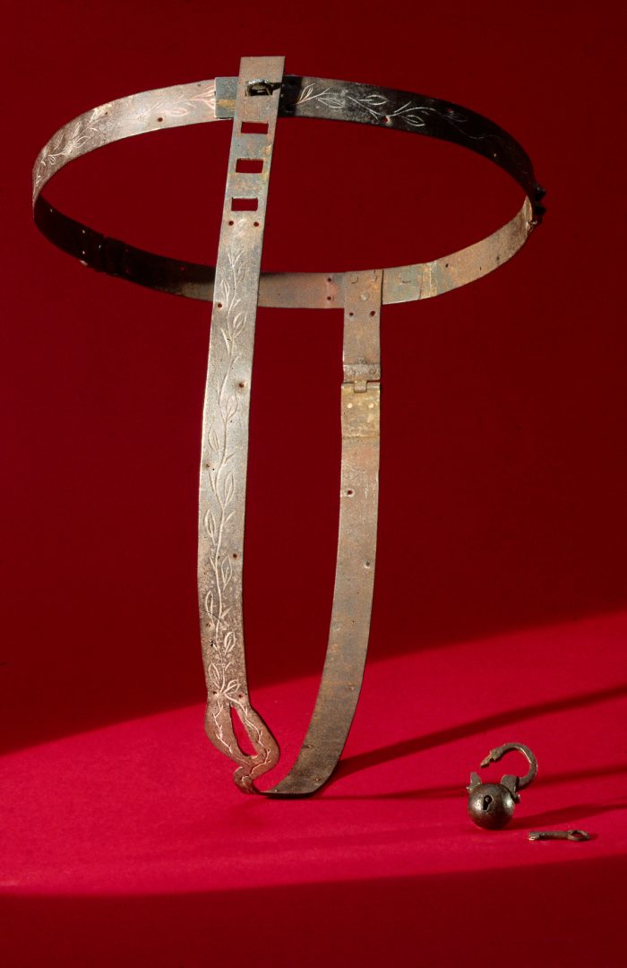 UNITED KINGDOM - NOVEMBER 22:  Chastity belts originated in the 15th century. They were devices designed to prevent the female wearer from having sexual intercourse, and incorporated openings to facilitate urination and defecation. They were locked to prevent their removal. Front view with padlock lying next to the belt.  (Photo by SSPL/Getty Images)